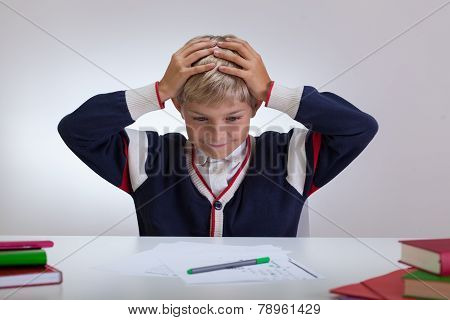 Schoolchild Touching His Head