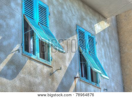 Turquoise Shutters In A Rustic Wall