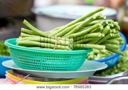 Pieces Of Yardlong Bean In Green Plastic Basket.