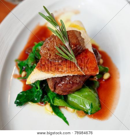 Tenderloin steak with beef terrine and spinach on plate