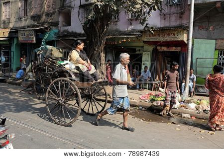 KOLKATA - FEB 12: rickshaw driver working on February 12, 2014 in Kolkata, India. Rickshaws have been around for more than a century, but they could soon be a thing of the past.