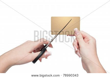 Close-up Of Woman Hands Cutting Gold Credit Card With Scissors