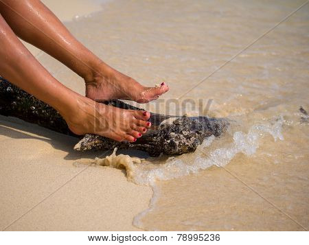 Woman feet on the sandy beach