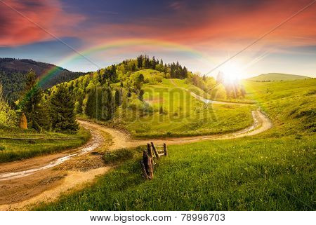 Cross Road On Hillside Meadow In Mountain At Sunset
