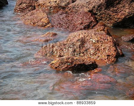 The sea wave runs on the desert stony coast