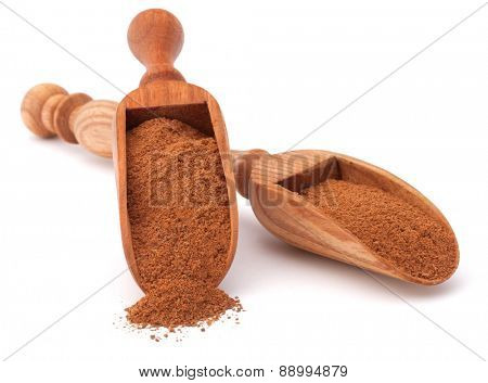 ground cinnamon spice powder in wooden spoon isolated on white background cutout