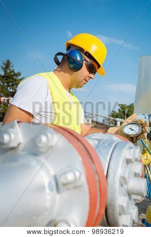 Oil worker in industrial oil