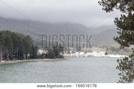 Lake in the mountains in winter on a foggy day (Greece, mountainous Corinthia)
