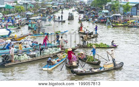 Soc Trang, Vietnam - January 21st, 2017: Farmers purchase crowded in floating market morning with dozens boats along river trade agricultural products serves traditional New Year in Soc Trang, Vietnam
