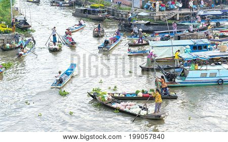 Soc Trang, Vietnam - January 21st, 2017: Farmers purchase crowded in floating market morning with dozens boats along river trade agricultural products serves traditional New Year in Soc Trang, Vietnam