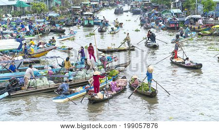 Soc Trang, Vietnam - January 21st, 2017: Farmers purchase crowded in floating market morning with dozens boats along river trade agricultural products serves traditional New Year in Soc Trang, Vietnam
