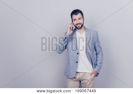 Cheerful Brunet Bearded Businessman Is Smiling, Talking To Business Partner About Success Of The Com