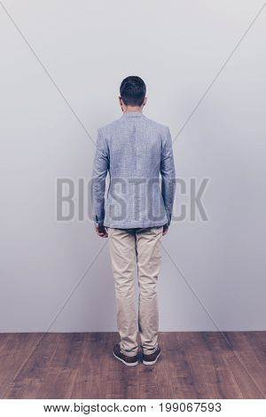 Snap Model Shot. Full Length Photo, Rear View, Guy In A Formal Wear, Stands On A Wooden Floor, Near
