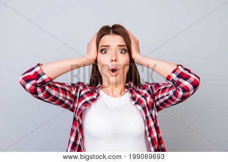 Really?! Shocked Brunette Girl Is Amazed With Wide Open Eyes, Mouth, Holding Head, In A Casual Check