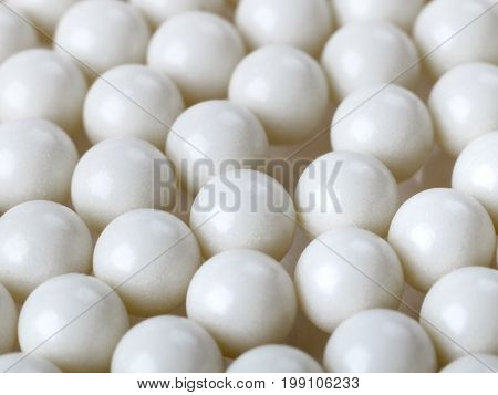 background with white plastic airsoft balls. selective focus