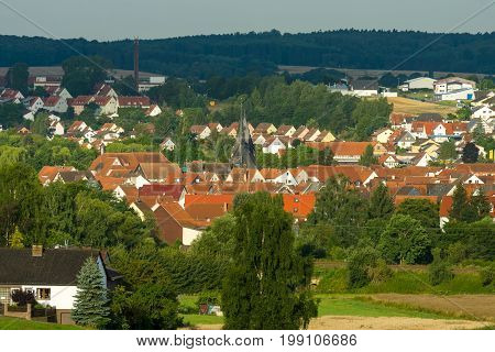 NEUSTADT GERMANY - JULY 31 2017: View of the small town of Neustadt (Marburg-Biedenkopf district in Hessen) the suburbs and surrounding agricultural land in the morning sun.