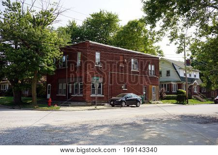 JOLIET, ILLINOIS / UNITED STATES - JULY 17, 2017: A two story brick apartment building stands at the corner of Wilcox and Douglas Streets.