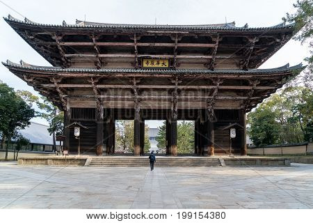 Gate of Todai-ji Temple with tourist walking in Nara Japan. Nara is a spectacularly picturesque city which is second only to Kyoto.
