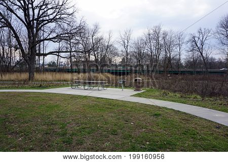 Picnickers may sit at a picnic table in the Hammel Woods Forest Preserve in Shorewood, Illinois.