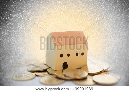House And  Golden Coins  With Bokeh Blurred Background,properties Concept