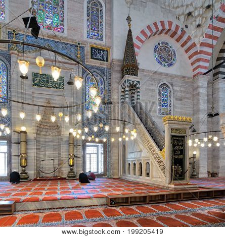 Istanbul Turkey - April 19 2017: Marble floral golden ornate minbar (Platform) and niche with few prayers at Suleymaniye Mosque Istanbul Turkey