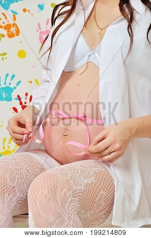 Belly of a pregnant woman in studio