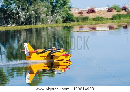 A floating Radio controlled model hydroplane speeds up to take off on Guadiana river Badajoz