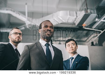 group of modern stylish multiethic businessmen in office