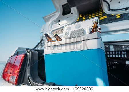 Close Up View Of Portable Fridge With Beer Standing In Car