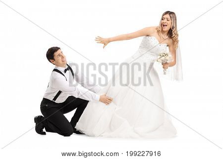 Groom trying to stop his bide from running away isolated on white background