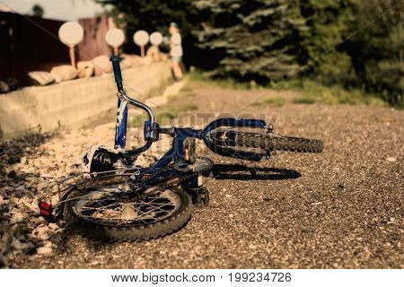 the boy threw his bike on the ground