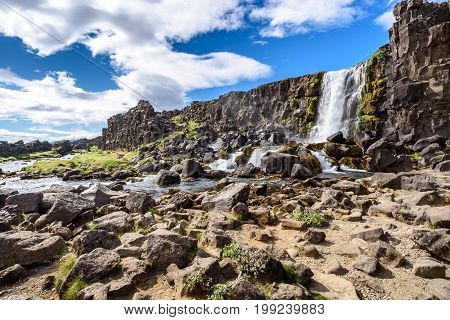 Beautiful Oxararfoss waterfall in summer Thingvellir National Park Iceland selective focus