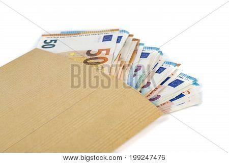Brown envelope full of euro banknotes bills onwhite background. Concept of corruption and bribery