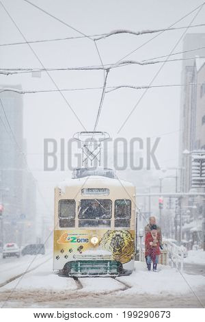 Toyama Japan - Jan 24 : Toyama Railway and Toyama city in snow day on JAN 24 2016 in Toyama Japan. Toyama Regional Railway is a transportation company in Toyama Toyama Japan. The company is commonly known as Chitetsu