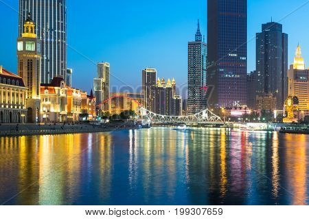 illuminated city waterfront downtown skyline with Haihe river,Tianjin,China.