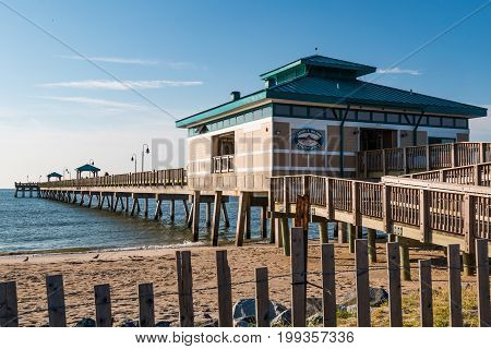 HAMPTON, VIRGINIA - JULY 9, 2017:  The James T. Wilson fishing pier, located at Buckroe Beach on the site of a former plantation.  The area is now popular for the beach, fishing and a public park.