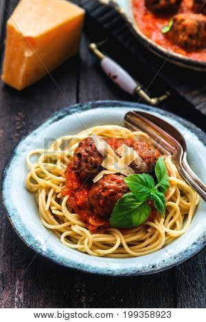 Itallian spaghetti and meatballs and parmegano for dinner, comfort food, close view.