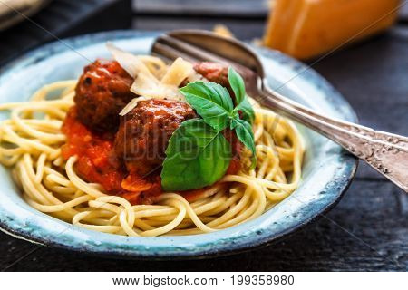 Itallian spaghetti and meatballs and parmegano for dinner, comfort food, close view.