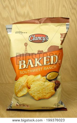 RIVER FALLS,WISCONSIN-AUGUST 12,2017: A bag of Clancy's brand southwest ranch flavored potato crisps with a wood background.
