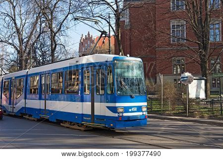 KRAKOW, POLAND - MARCH 28, 2017: Tram MAN N8S-NF in the historic part of Krakow. Total in Krakow more than 90 kilometers of tram tracks and 24 routes.