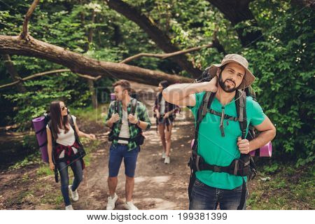 Hard, Difficult, Tiring And Exhausting Expedition Of Four Friends In Wild Forest In Trail. Guy Is St