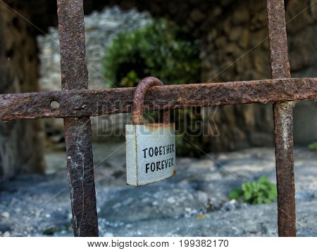 Padlock lovers hanging on the grate. Tuscan summer...