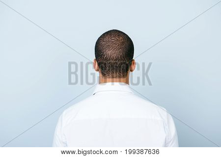 Rear View Of An American Muklatto Guy, In Smart White Formal Shirt, Standing On A Pure Blue Backgrou