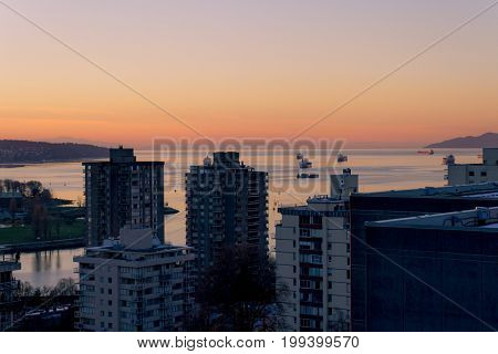 Morning Cityscape With Sunrise Illuminating Top Of Building
