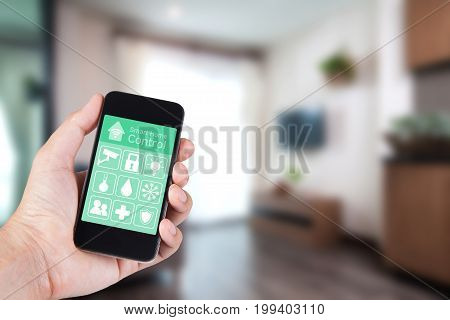 Hand using smartphone to smart home app on mobile for remote control everything in home by wifi network.
