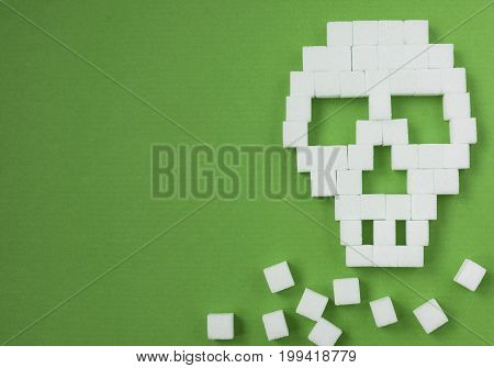 The skull made from sugar cubes. Sugar Kills.  background. diabetes concept. Suggesting dieting concept. Unhealthy white sugar concept. Copy space. Space for text.