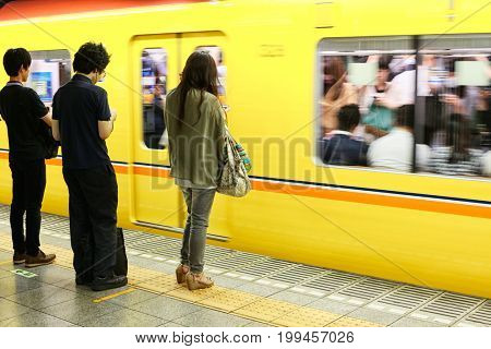 Tokyo, Japan - August 10, 2016: Passengers traveling by Tokyo metro. Business people commuting to work by public transport in rush hour. In Tokyo, Japan 