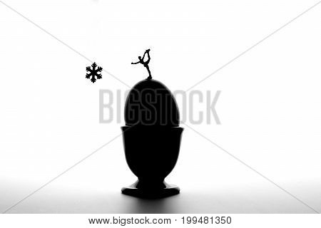 macro of miniature figure skater on eggs