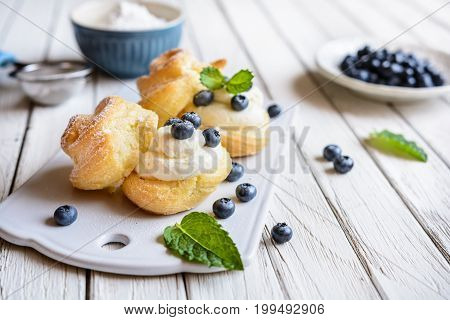 Cream Puffs Filled With Vanilla Cream And Blueberries
