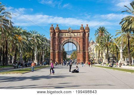 BARCELONA SPAIN - OCTOBER 22 2015: The Arc de Triomf is a triumphal arch in the city of Barcelona in Catalonia Spain. The arch is built in reddish brickwork in the Neo-Mudejar style